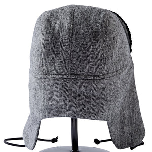 Detail image of the back side of a black and white wool Trapper of Colorado brand dressy "trapper hat" or "bomber hat" with black satin lining and black faux fur vegan brim for men or women to wear