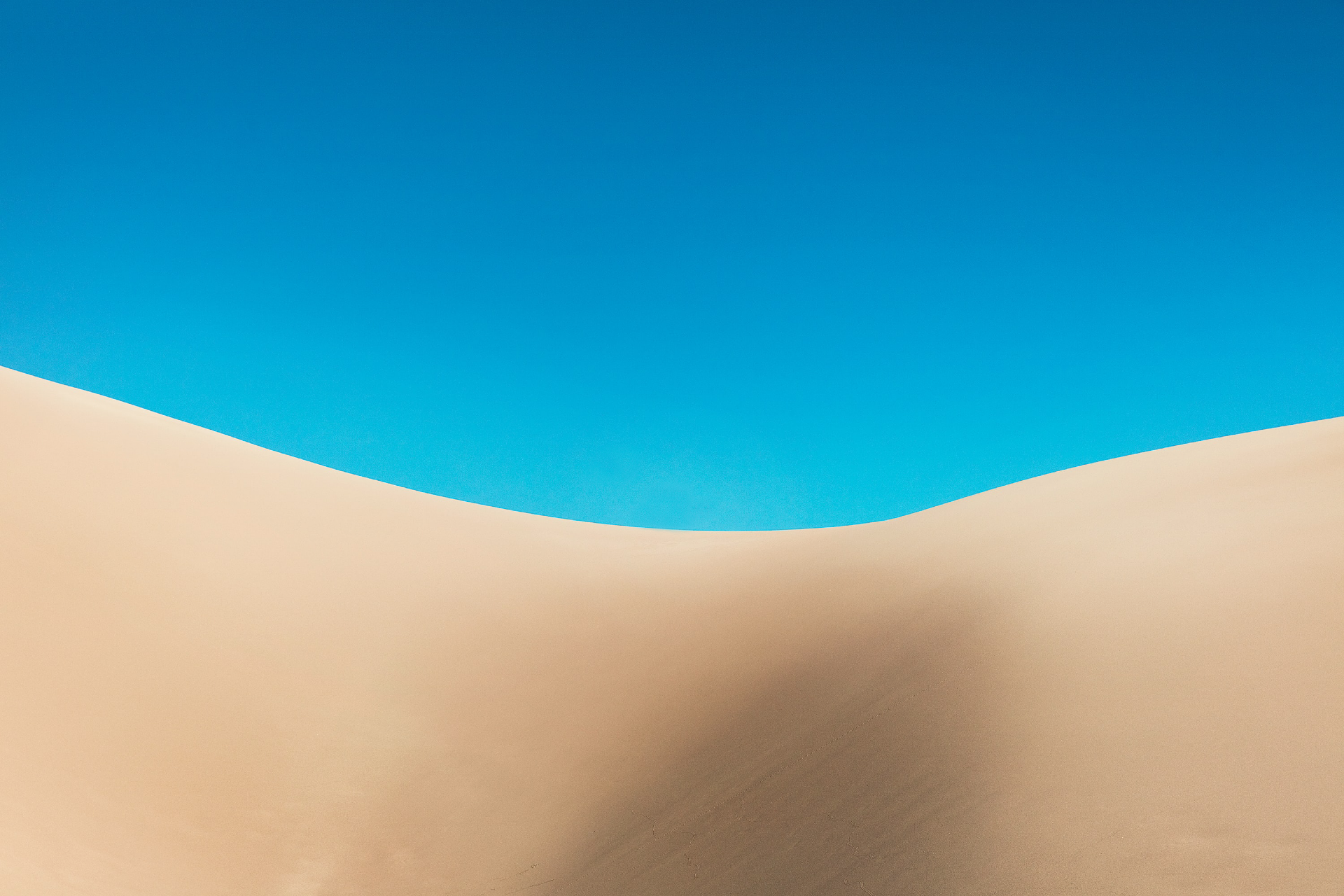 giant sand dunes with bright blue sky behind at Great Sand Dunes National Park Colorado USA