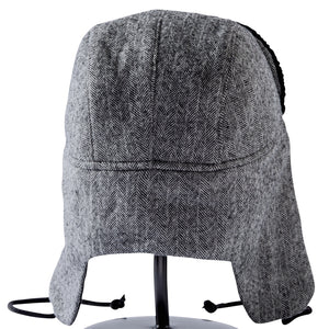 Detail image of the back side of a black and white wool Trapper of Colorado brand dressy "trapper hat" or "bomber hat" with black satin lining and  black faux fur vegan brim for men or women to wear